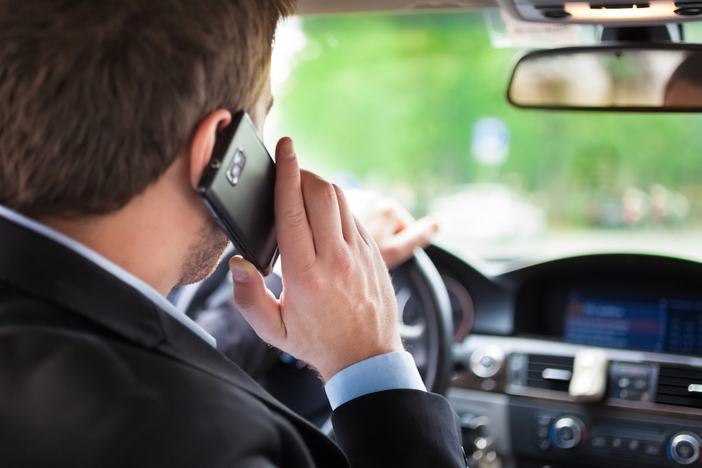 man on phone driving